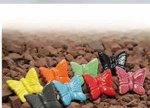 Detailed macro view of colorful butterfly ceramic drawer knobs with embossed texture
