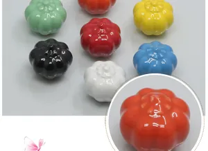 Polished pumpkin ceramic cabinet knobs in various colors like mint green and orange