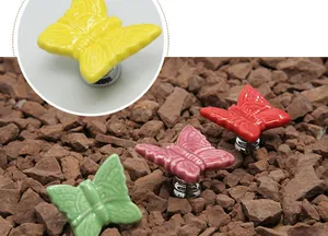 Detailed macro view of colorful ceramic butterfly knobs for cabinets and drawers