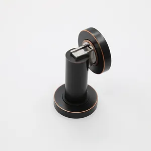 Macro detail of magnetic door stopper in matte black and bronze finish for wall mounting