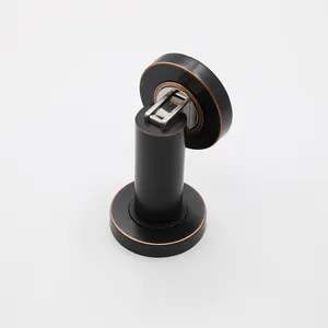 Macro detail of red bronze magnetic door stopper with cylindrical base and metal head