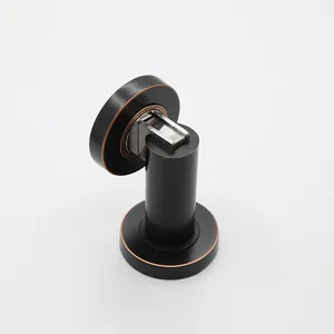 Close-up of magnetic door stopper with matte black and red bronze finish on white background