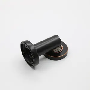 Detailed view of the industrial vintage matte black magnetic door stopper with bronze accents