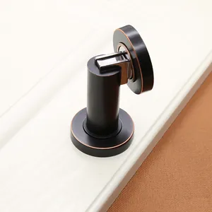 Close-up of magnetic zinc alloy door stopper with antique bronze edges in matte black