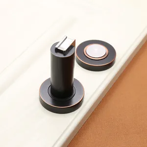Macro detail of bronze zinc alloy magnetic door stopper with cylindrical suction head
