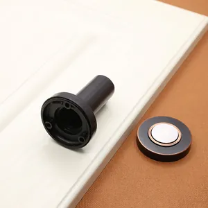 Detail of matte black magnetic door stopper with brushed zinc alloy texture and screw holes