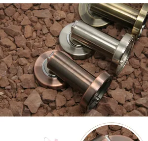 Zinc alloy magnetic door stoppers in bronze and silver finishes on stone background