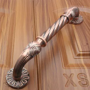 Detail of antique bronze door handle with spiral twist and embossed floral base