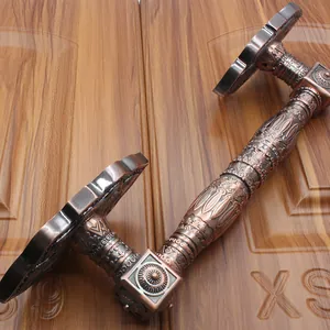 Detailed view of ornate carvings on European antique bronze door handles for villas