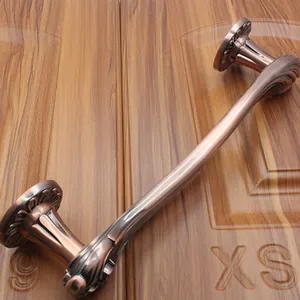 Detailed macro view of antique bronze door handle with embossed relief patterns