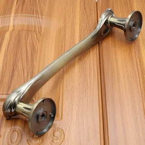 Close-up of antique bronze door handle with brushed texture and ornate round base
