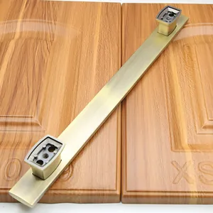 Macro view of antique bronze handle with brushed texture on wooden cabinet door