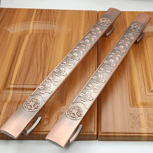 Detail of antique bronze door handles with exquisite floral relief and brushed metal finish