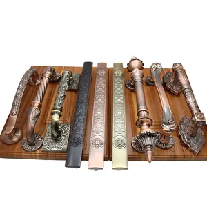 Antique European bronze door handles with ornate embossed patterns for wooden doors