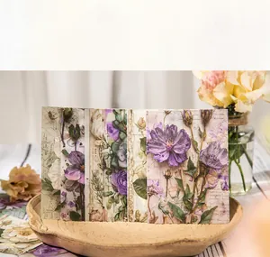 Macro detail of vintage floral scrapbooking paper with map textures in a wooden tray