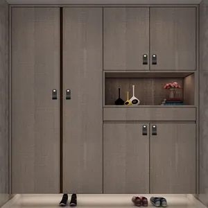 Modern black leather drawer pull with brass fastener on a textured cabinet door