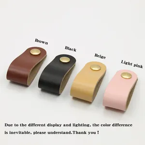 Close-up of leather cable organizers in brown, black, beige, and pink with gold snaps