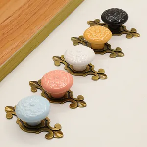Detailed macro of ceramic knobs with embossed floral patterns and bronze alloy bases