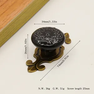 Macro view of vintage ceramic floral drawer knob with antique bronze scroll base
