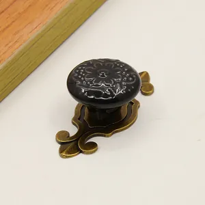 Macro detail of vintage floral ceramic cabinet knob with antique bronze metal base