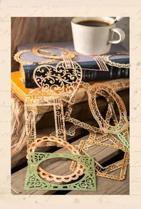 Detailed view of vintage hollow lace paper frames in various shapes for scrapbooking decor