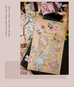 Close-up of vintage floral scrapbooking stickers with lace and butterfly paper cutouts