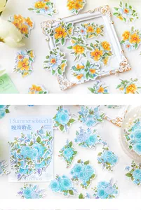 Detail of watercolor floral scrapbooking stickers in blue and orange floral themes
