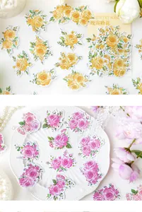 Detailed view of vintage floral scrapbooking stickers in yellow and pink hues