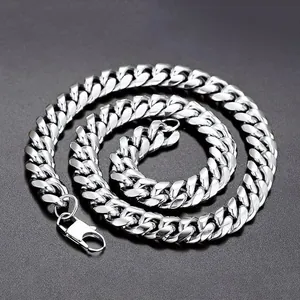 Detailed view of polished silver cuban link chain with secure industrial lobster clasp