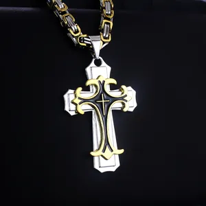 Detailed view of triple-layered cross pendant with golden patterns and Byzantine chain