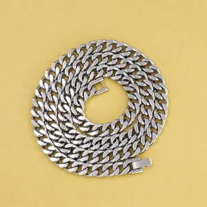 Detailed top view of silver Cuban link chain necklace with rectangular clasp on yellow background