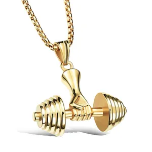 Golden fitness dumbbell pendant necklace featuring a powerful hand grip on a barbell
