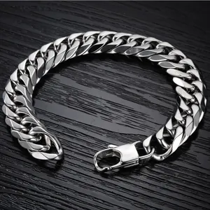 Polished stainless steel Cuban link necklace with large lobster clasp on dark background