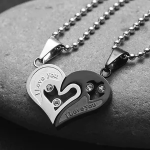 Macro shot of two-tone heart puzzle pendant with I Love You engraving and small crystals