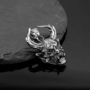 Macro view of vintage silver steel demon skull pendant with horns and detailed fangs