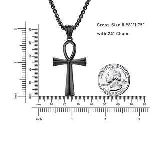 Size reference of black Ankh cross pendant with 24 inch chain next to a US quarter coin