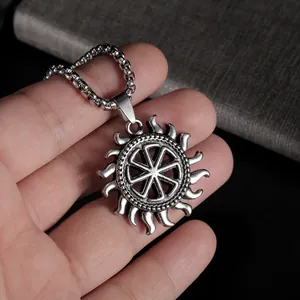 Close-up of Slavic Kolovrat sun pendant with vintage oxidized finish on pearl chain