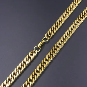 Close-up of golden Cuban link chain with lobster clasp on dark textured background