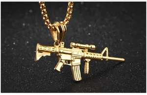 Detailed close-up of golden rifle pendant necklace with intricate tactical details