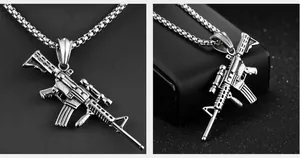 Detail shot of vintage silver AK47 rifle pendant with tactical scope on stainless chain