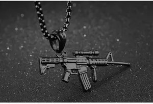 Macro shot of detailed black matte AK47 assault rifle pendant with bead chain