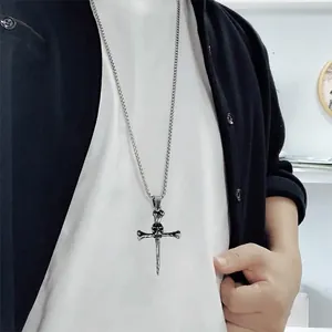Men's gothic skull cross pendant necklace with vintage silver finish on model