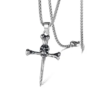 Detail view of gothic skeleton skull cross pendant with vintage oxidized steel finish