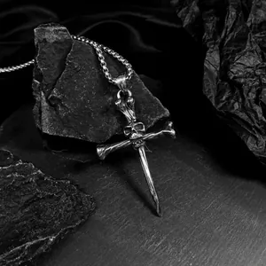 Macro view of gothic skull cross pendant on black stone, dark punk style jewelry