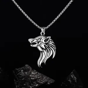 Detailed macro view of a 3D wolf head pendant featuring polished stainless steel finish