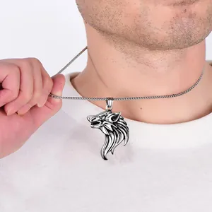 Detail of men's stainless steel wolf head pendant necklace on a male model wearing a white tee
