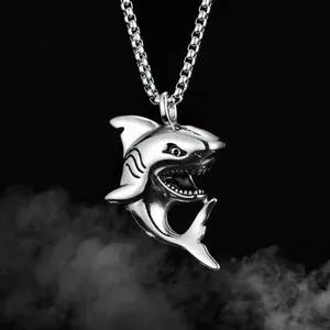 Detailed close-up of a shark-shaped stainless steel pendant with hip hop chain on black background