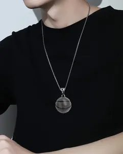 Close-up of retro basketball pendant with realistic texture on steel chain necklace