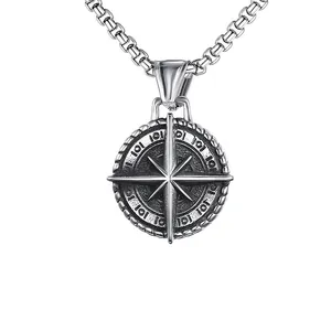 Detailed close-up of retro silver compass cross pendant with vintage box chain link necklace