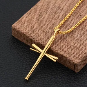 Macro view of gold baseball bat cross pendant with polished texture on a leather base